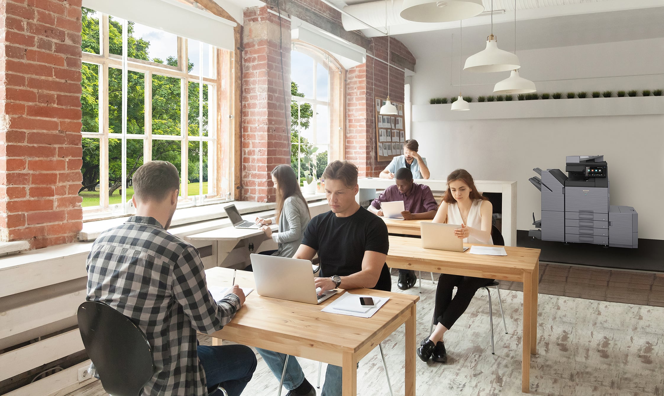 Young casually dressed employees at work in shared coworking office