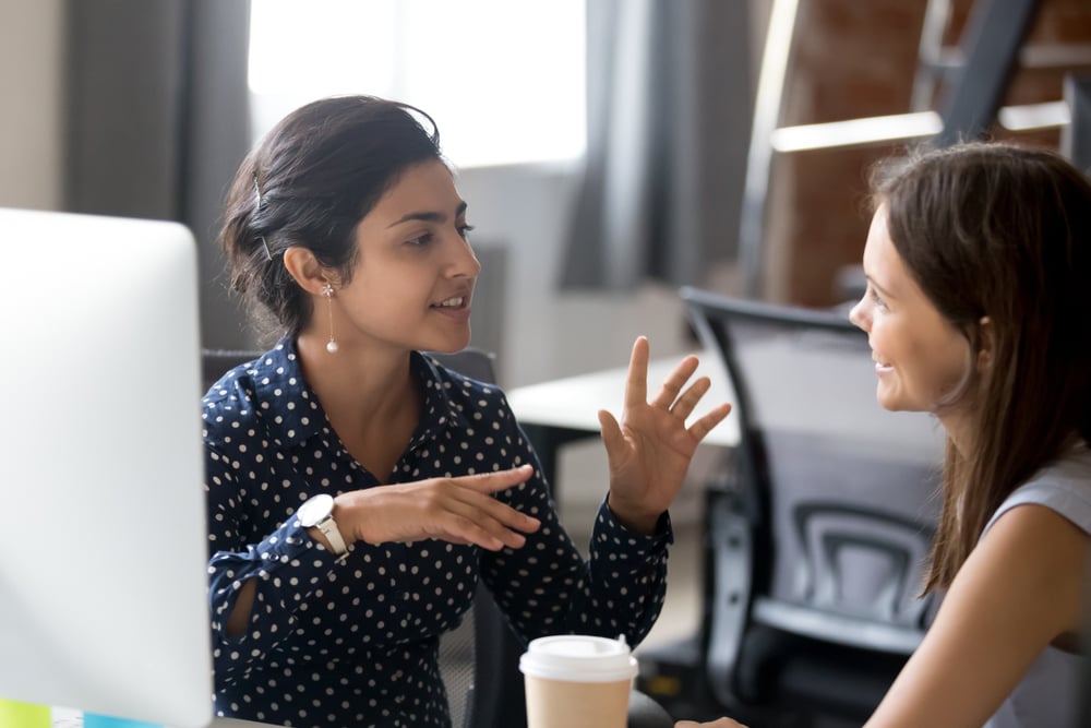 FriendlyFemaleColleaguesHavingGoodRelationshipsPleasantConversationAtWorkplace