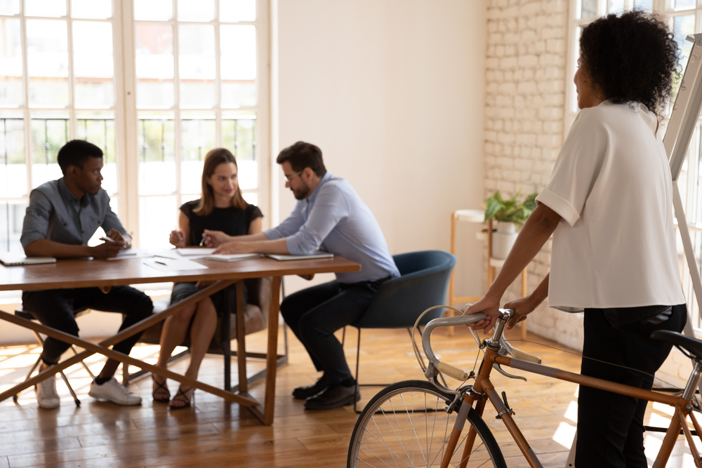 DiverseBusinesspeopleTalkSitAtDeskInOfficeFocusOn