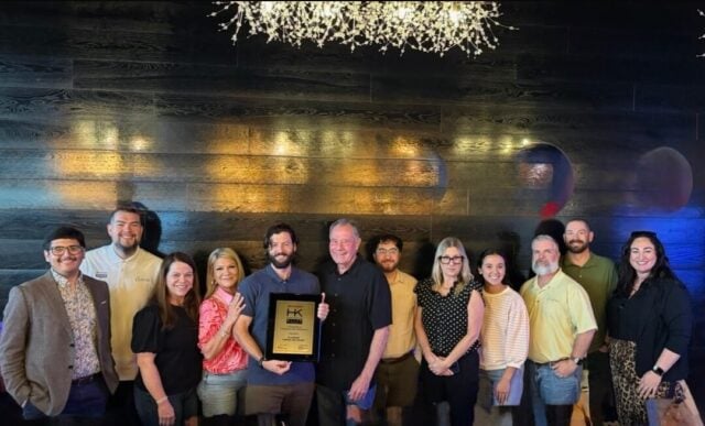 Why houston businesses choose platinum copier solutions | platinum copier solutions Group of People Posing Together Indoors Holding a Plaque As an Award Centerpiece