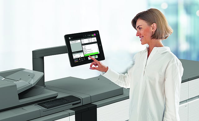 | platinum copier solutions Woman Using a Large Office Multifunction Printer Touching Its Touchscreen Control Panel