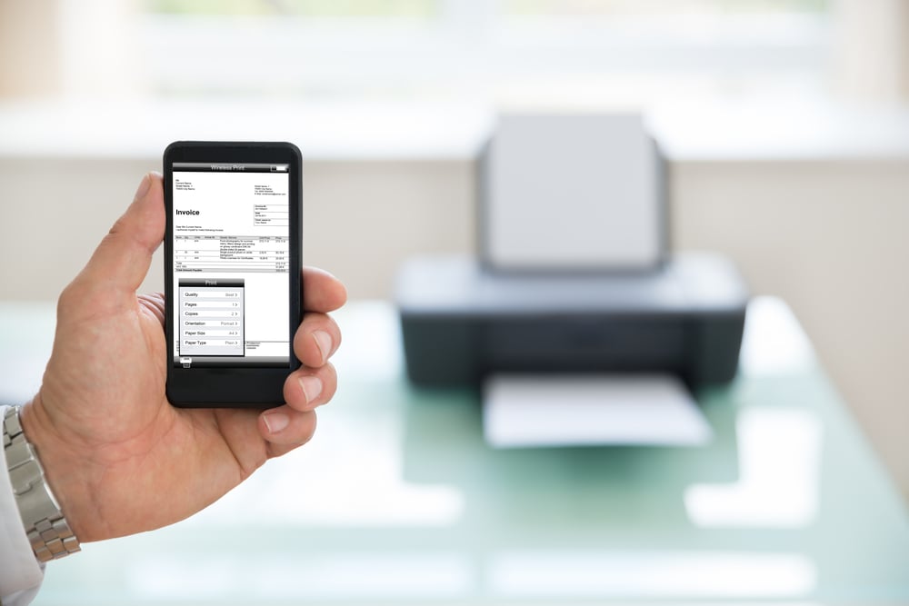 Close-up Of A Businessman Using Cellphone For Printing Invoice. Photographer owns copyright for images on screen.